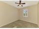 Neutral bedroom features a ceiling fan, a carpeted floor, and a window with shutters at 9022 Coachman Dr, Venice, FL 34293