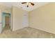 Bedroom features a ceiling fan, carpeted floor, and an entrance to another room at 9022 Coachman Dr, Venice, FL 34293
