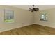 Bright bedroom boasts wood-look floors, neutral walls, and a modern ceiling fan at 9022 Coachman Dr, Venice, FL 34293