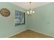Eat-in nook with a large window view, pendant lighting and neutral paint at 9022 Coachman Dr, Venice, FL 34293