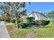 Well-maintained home exterior featuring lush green lawn and meticulously trimmed shrubs at 9022 Coachman Dr, Venice, FL 34293