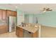 Bright kitchen with stainless steel appliances, granite counters, and an eat-in breakfast bar at 9022 Coachman Dr, Venice, FL 34293