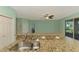 Spacious kitchen with stainless steel appliances, a breakfast bar, and ample countertop space at 9022 Coachman Dr, Venice, FL 34293