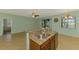 Kitchen island features granite countertops and stainless steel appliances in an open layout at 9022 Coachman Dr, Venice, FL 34293