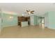 Open-concept kitchen features stainless steel appliances, brown cabinetry, and a granite-topped breakfast bar at 9022 Coachman Dr, Venice, FL 34293