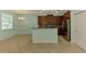 Well-lit kitchen and breakfast nook area featuring granite countertops and stainless steel appliances at 9022 Coachman Dr, Venice, FL 34293