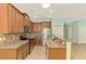 Open kitchen with granite counters and backsplash, stainless steel appliances, and brown cabinets at 9022 Coachman Dr, Venice, FL 34293
