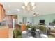 Open concept kitchen and dining area featuring stainless steel appliances and a granite-topped island with bar seating at 9022 Coachman Dr, Venice, FL 34293