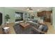 Inviting living room with modern decor, ceiling fan, and sliding glass doors to the outdoor area with water views at 9022 Coachman Dr, Venice, FL 34293