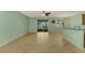 Open-concept living space with tile flooring, breakfast bar, and sliding glass doors to the lanai at 9022 Coachman Dr, Venice, FL 34293