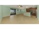 Open-concept living space with tile flooring, breakfast bar, and sliding glass doors to the lanai at 9022 Coachman Dr, Venice, FL 34293