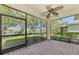 Screened patio with brick flooring overlooking a serene lake at 9022 Coachman Dr, Venice, FL 34293
