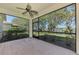 Enclosed patio overlooks lush landscaping and a beautiful lake at 9022 Coachman Dr, Venice, FL 34293