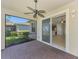 Screened patio with ceiling fan offers views into the home at 9022 Coachman Dr, Venice, FL 34293