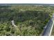 Aerial view of wooded lot with road access at 9625 Erie Rd, Parrish, FL 34219