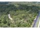 Aerial view of wooded lot with a path leading up to it from the road at 9625 Erie Rd, Parrish, FL 34219