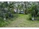 Large backyard with swing set and RV parked behind the trees at 9625 Erie Rd, Parrish, FL 34219