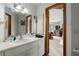 Bathroom with white cabinetry and a well-lit mirror at 9625 Erie Rd, Parrish, FL 34219