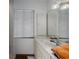 Bathroom featuring a large mirror, tile, and great natural light at 9625 Erie Rd, Parrish, FL 34219