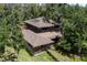 Stunning two-story home with solar panels and a deck nestled amongst mature trees at 9625 Erie Rd, Parrish, FL 34219