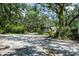 Exterior shot of the home with mature landscaping surrounding the dwelling at 9625 Erie Rd, Parrish, FL 34219