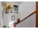 Hallway decorated with artwork, leading up stairs with wood trim at 9625 Erie Rd, Parrish, FL 34219