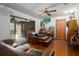 Comfortable living room features wood floors, ceiling fan and access to a screened in porch at 9625 Erie Rd, Parrish, FL 34219