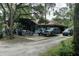 View of the yard area with multiple vehicles and outdoor decor at 9625 Erie Rd, Parrish, FL 34219