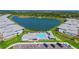 Overhead view of a condo community featuring a pool, lake, and convenient parking at 1017 Tidewater Shores Loop # 1017, Bradenton, FL 34208
