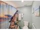 Bathroom featuring a shower with an image of the Amalfi coast and a toilet at 1017 Tidewater Shores Loop # 1017, Bradenton, FL 34208