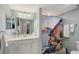 Bathroom featuring a beautiful mirror and a shower with an image of the Amalfi coast at 1017 Tidewater Shores Loop # 1017, Bradenton, FL 34208