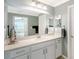 Bright bathroom featuring a large mirror and a white vanity with granite countertops at 1017 Tidewater Shores Loop # 1017, Bradenton, FL 34208