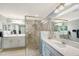 Bright bathroom featuring a glass-enclosed shower, double vanity, and granite countertops at 1017 Tidewater Shores Loop # 1017, Bradenton, FL 34208