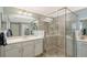 Modern bathroom featuring a large glass-enclosed shower and double vanity sinks with ample counter space at 1017 Tidewater Shores Loop # 1017, Bradenton, FL 34208