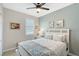 Bedroom featuring a ceiling fan, a window, and a bed with decorative pillows at 1017 Tidewater Shores Loop # 1017, Bradenton, FL 34208