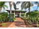 Entrance with brick walkway leading to building entrance framed by lush landscaping at 1017 Tidewater Shores Loop # 1017, Bradenton, FL 34208