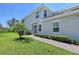 Charming two-story townhome featuring a paved walkway, green lawn, lush landscaping, and gray color scheme at 1017 Tidewater Shores Loop # 1017, Bradenton, FL 34208