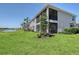 Beautiful condo exterior with well-maintained lawn, screened lanai, and tranquil views of the pond at 1017 Tidewater Shores Loop # 1017, Bradenton, FL 34208