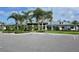 Exterior view of community building with parking, landscaping, and American flags at 1017 Tidewater Shores Loop # 1017, Bradenton, FL 34208