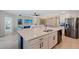 Spacious kitchen with a large center island, stainless steel appliances, and an open view to the living area at 1017 Tidewater Shores Loop # 1017, Bradenton, FL 34208