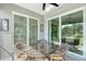 Charming screened-in lanai with a wicker dining set, offering an inviting space to enjoy outdoor meals and views at 1017 Tidewater Shores Loop # 1017, Bradenton, FL 34208