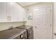 Convenient laundry room with modern washer and dryer, and ample storage cabinets for organization at 1017 Tidewater Shores Loop # 1017, Bradenton, FL 34208