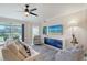 Comfortable living room with stylish decor, ceiling fan, and access to the screened-in lanai with scenic outdoor views at 1017 Tidewater Shores Loop # 1017, Bradenton, FL 34208