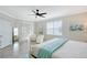Bright and airy main bedroom featuring tile floors, ceiling fan, and a view of the outdoor area at 1017 Tidewater Shores Loop # 1017, Bradenton, FL 34208
