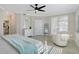 Spacious main bedroom featuring a ceiling fan, tile floors, and a comfortable seating area at 1017 Tidewater Shores Loop # 1017, Bradenton, FL 34208