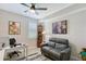 Office featuring a desk, leather couch, grandfather clock, and beach-themed art at 1017 Tidewater Shores Loop # 1017, Bradenton, FL 34208