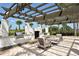 Outdoor kitchen with grill, countertop space, and comfortable seating area under a pergola at 1017 Tidewater Shores Loop # 1017, Bradenton, FL 34208