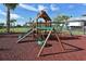 Community playground with a wooden playset featuring a slide, swings, and climbing structure at 1017 Tidewater Shores Loop # 1017, Bradenton, FL 34208