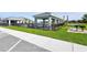 Community pool area with a gazebo, BBQ grills, and well-manicured lawn at 1017 Tidewater Shores Loop # 1017, Bradenton, FL 34208