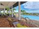 Community pool features comfortable lounge area with palm trees and water views at 1017 Tidewater Shores Loop # 1017, Bradenton, FL 34208